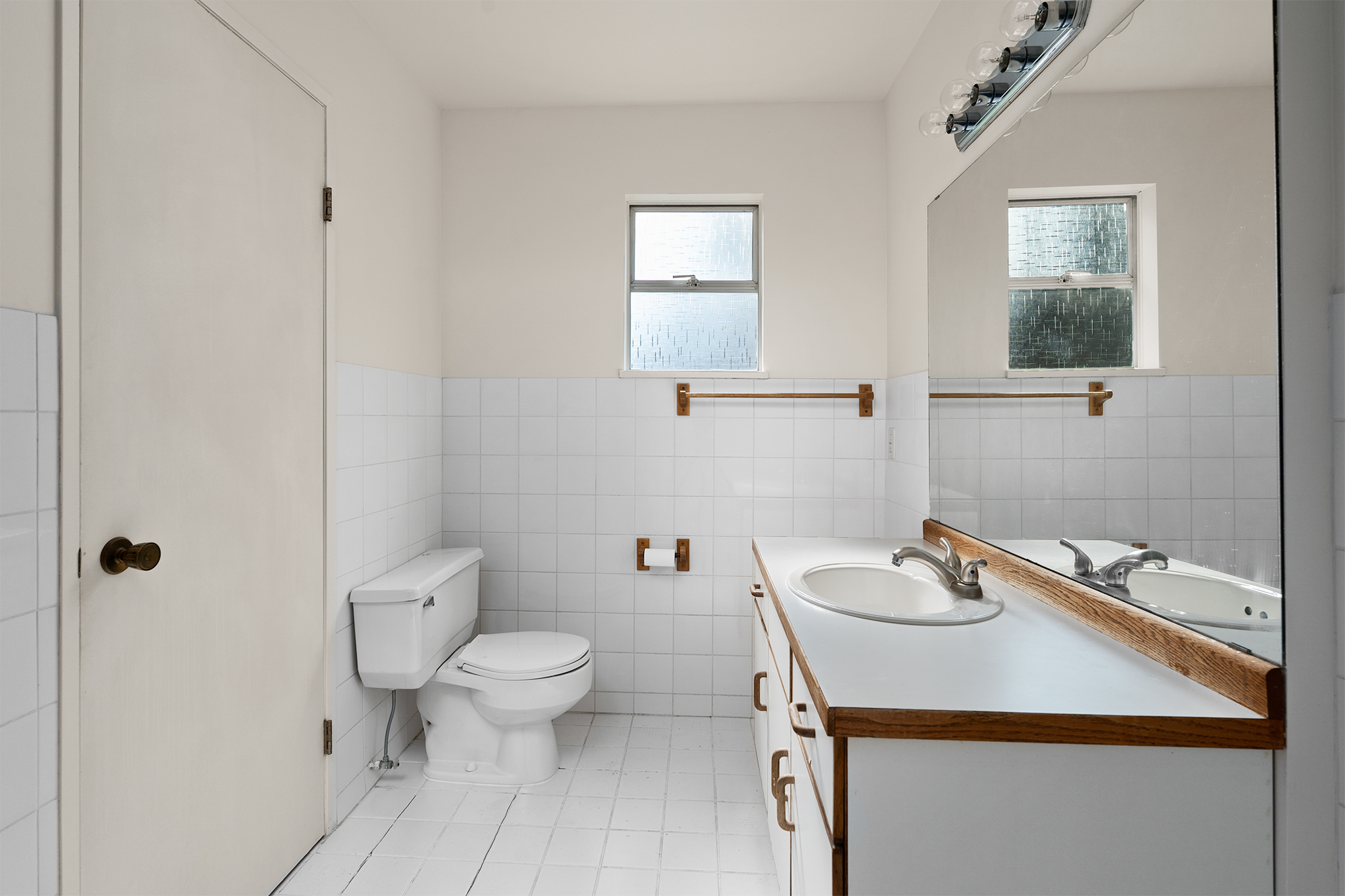 Bathroom before renovation - original dated bathroom