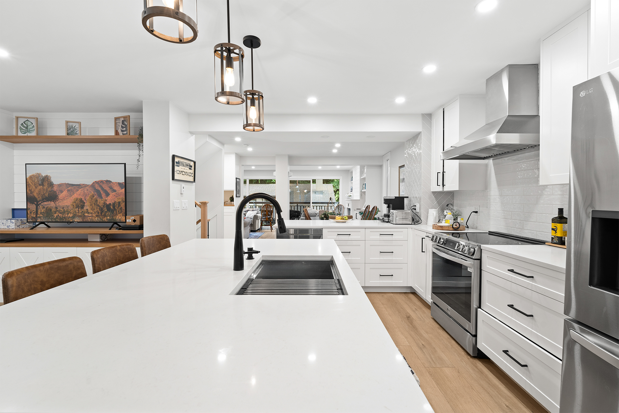 After kitchen renovation - stunning open concept kitchen with white cabinets and modern finishes